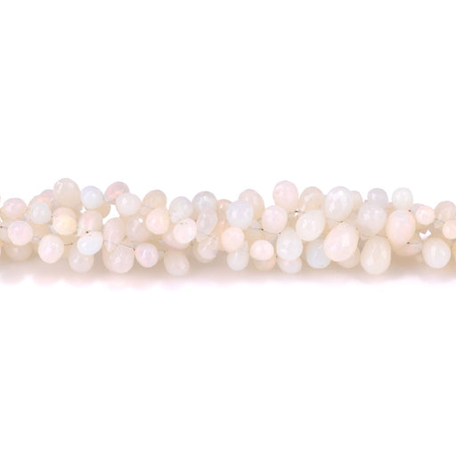 This is a Dakota Stones 4x6-7x10mm Ethiopian Opal White Gemstone strand with faceted drop beads in 15-16 inch strand.