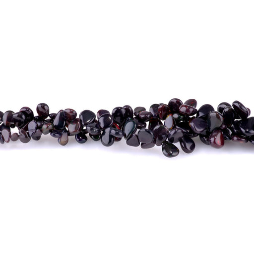 This is a Dakota Stones 4x9-12mm Ethiopian Opal Pear Black Gemstone strand of round beads in 15-16 inch strand.