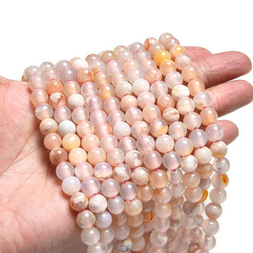 This is a Dakota Stones 8mm Flower Agate Large Hole Gemstone strand with round beads in 8 inch strand.