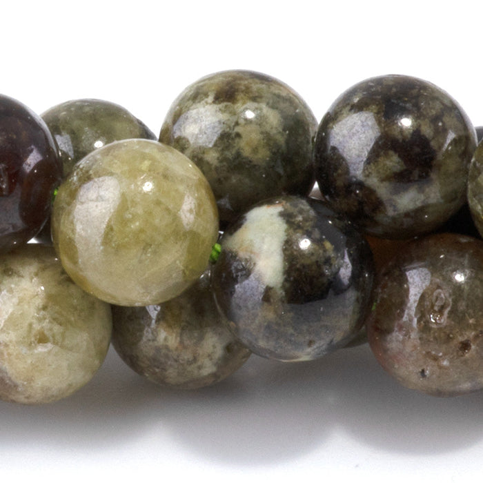 This is a Dakota Stones 10mm Green Garnet Gemstone strand with round beads in 15-16 inch strand.