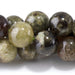 This is a Dakota Stones 10mm Green Garnet Gemstone strand with round beads in 15-16 inch strand.