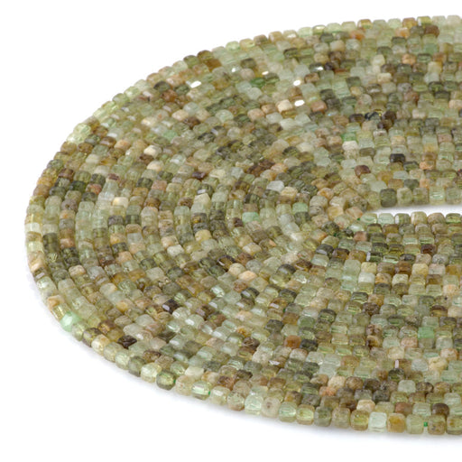 This is a Dakota Stones 3mm Green Garnet Gemstone strand with table-cut faceted cube beads in 15-16 inch strand.