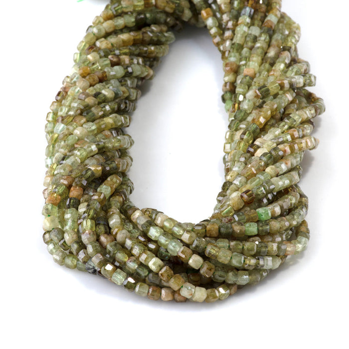 This is a Dakota Stones 3mm Green Garnet Gemstone strand with table-cut faceted cube beads in 15-16 inch strand.