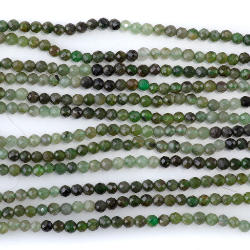 This is a Dakota Stones 3mm Green Garnet Banded Gemstone strand with faceted round beads in 15 inch strand.