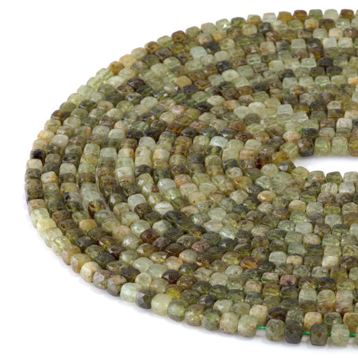 This is a Dakota Stones 4mm Green Garnet Gemstone strand with faceted cube beads in 15-16 inch strand.