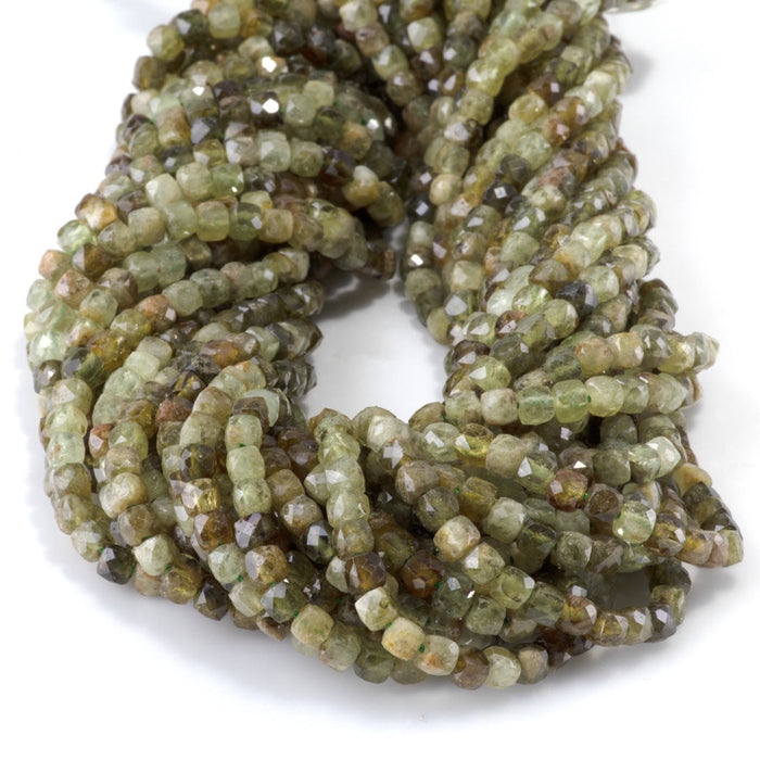 This is a Dakota Stones 4mm Green Garnet Gemstone strand with faceted cube beads in 15-16 inch strand.