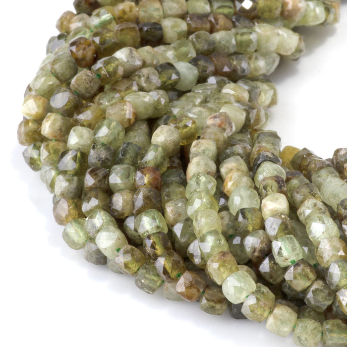 This is a Dakota Stones 4mm Green Garnet Gemstone strand with faceted cube beads in 15-16 inch strand.