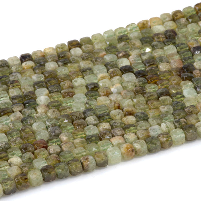 This is a Dakota Stones 4mm Green Garnet Gemstone strand with faceted cube beads in 15-16 inch strand.