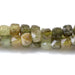 This is a Dakota Stones 4mm Green Garnet Gemstone strand with faceted cube beads in 15-16 inch strand.