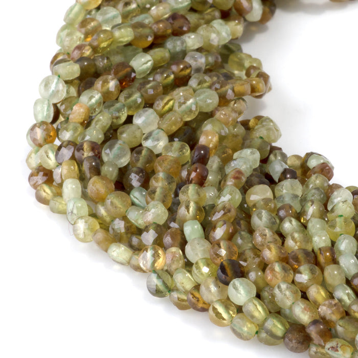 This is a Dakota Stones 4mm Green Garnet Gemstone strand with faceted coin beads in 15-16 inch strand.