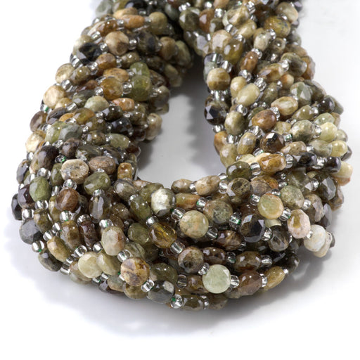 This is a Dakota Stones 6mm Green Garnet Cut Gemstone strand with coin star beads in 15-16 inch strand.