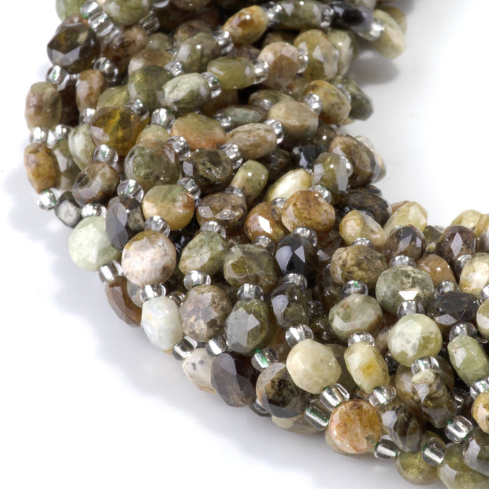 This is a Dakota Stones 6mm Green Garnet Cut Gemstone strand with coin star beads in 15-16 inch strand.