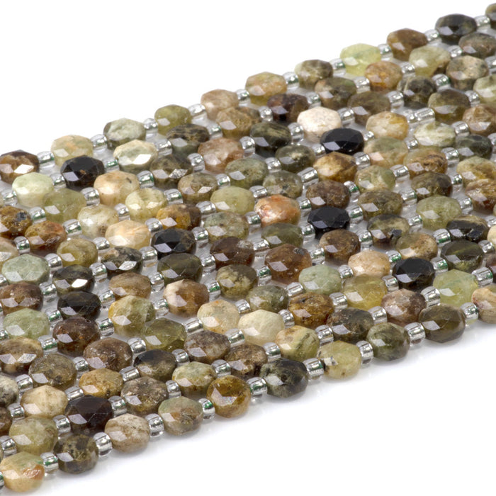 This is a Dakota Stones 6mm Green Garnet Cut Gemstone strand with coin star beads in 15-16 inch strand.