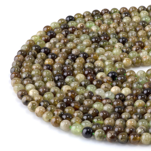 This is a Dakota Stones 6mm Green Garnet Gemstone strand with round beads in 15-16 inch strand.
