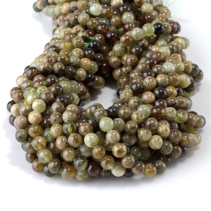This is a Dakota Stones 6mm Green Garnet Gemstone strand with round beads in 15-16 inch strand.