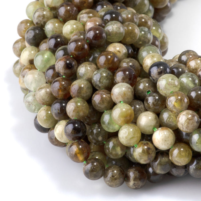This is a Dakota Stones 6mm Green Garnet Gemstone strand with round beads in 15-16 inch strand.