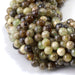 This is a Dakota Stones 6mm Green Garnet Gemstone strand with round beads in 15-16 inch strand.