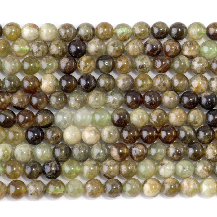 This is a Dakota Stones 6mm Green Garnet Gemstone strand with round beads in 15-16 inch strand.