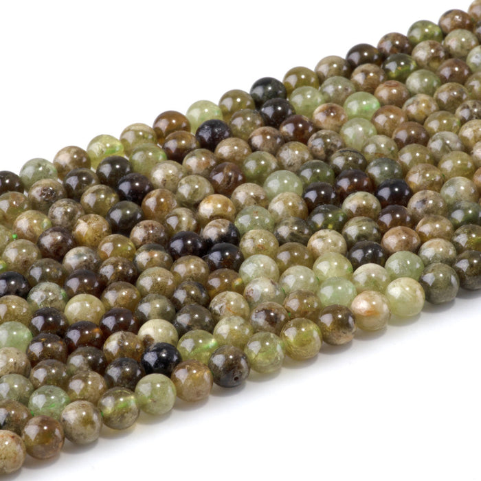 This is a Dakota Stones 6mm Green Garnet Gemstone strand with round beads in 15-16 inch strand.