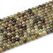 This is a Dakota Stones 6mm Green Garnet Gemstone strand with round beads in 15-16 inch strand.