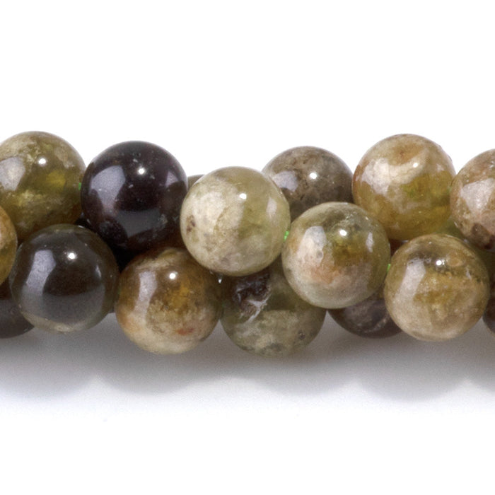 This is a Dakota Stones 6mm Green Garnet Gemstone strand with round beads in 15-16 inch strand.