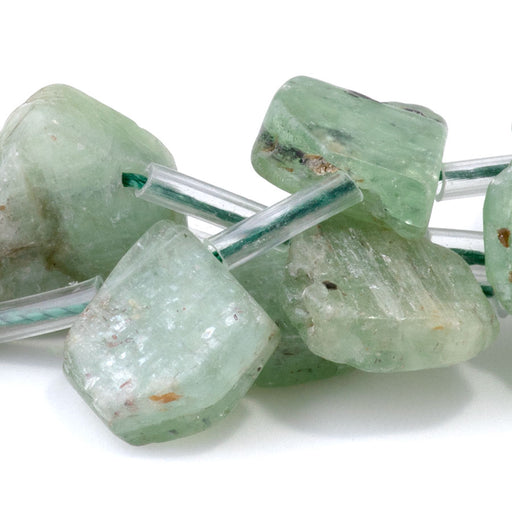 This is a Dakota Stones 9x13-12x16mm Green Kyanite Top Drill Flat Gemstone strand with irregular drop beads in 15-16 inch strand.