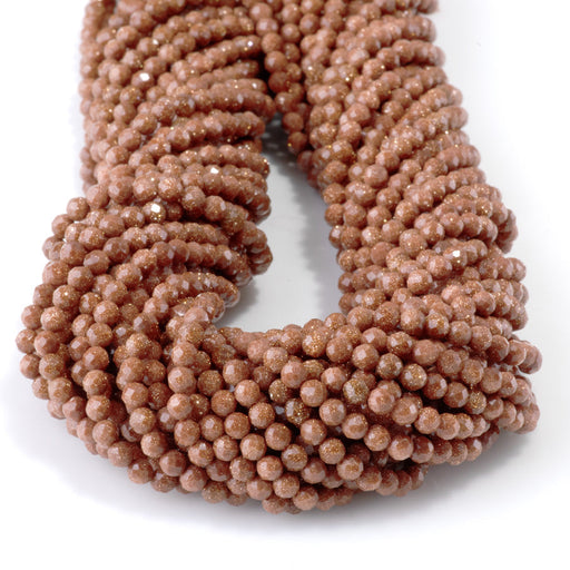 This is a Dakota Stones 3-4mm Special Price Goldstone Gemstone strand with faceted round beads in 15 inch strand.