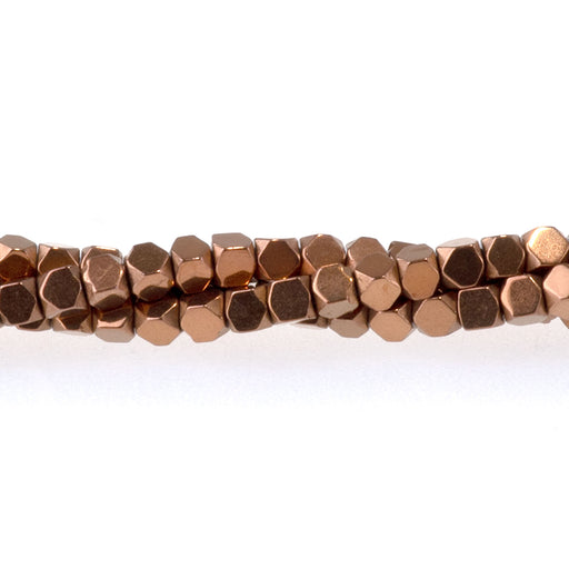 This is a Dakota Stones 2mm Cut Hematite Copper Plated Cut Gemstone strand with cube beads in 15-16 inch strand.