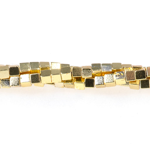 This is a Dakota Stones 2mm Hematite Dark Gold Plated Gemstone strand with cube beads in 15-16 inch strand.