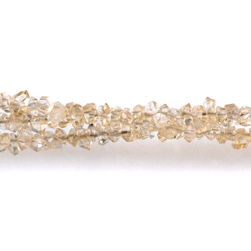This is a Dakota Stones 1-3mm Cream Herkimer Quartz Point Gemstone strand of round beads in 15-16 inch strand.