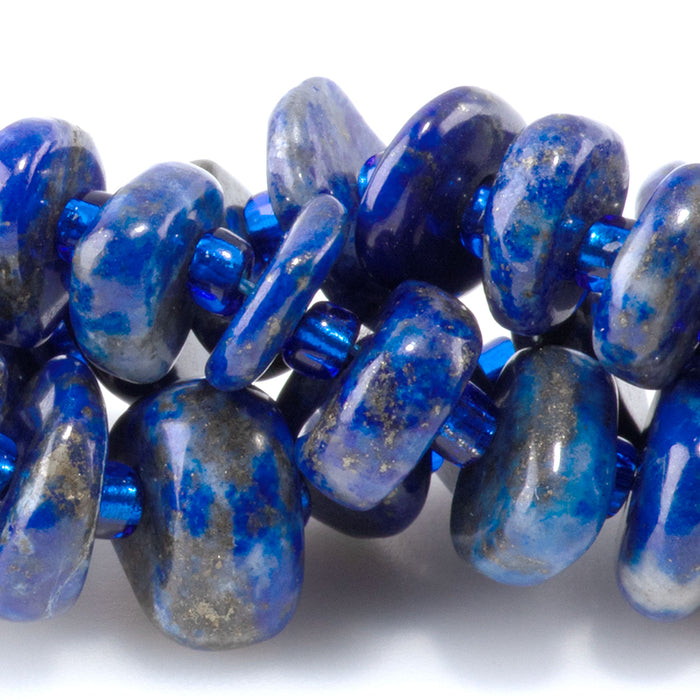 This is a Dakota Stones 5x8mm Lapis Gemstone strand with chip beads in 15-16 inch strand.