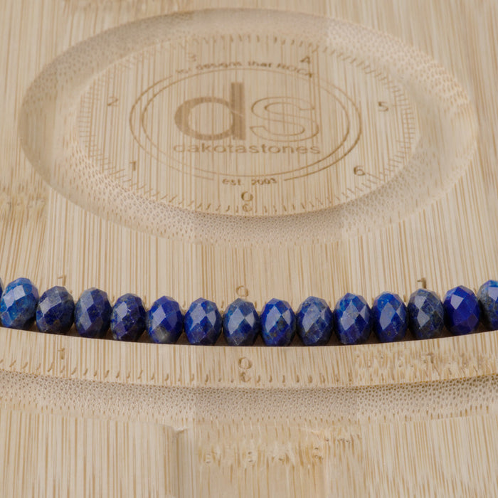 This is a Dakota Stones 5x8mm Lapis Gemstone strand with faceted rondelle beads in 15-16 inch strand.