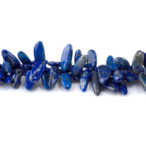 This is a Dakota Stones 6x12-10x20mm Lapis Dancing Drops Gemstone strand with A grade free-form beads in 15-16 inch strand.