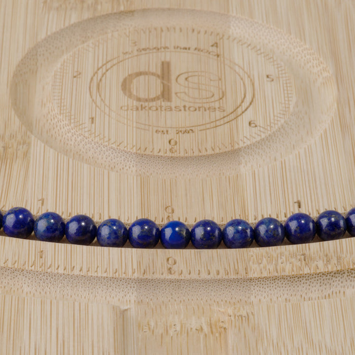This is a Dakota Stones 6mm Lapis Gemstone strand with AAA grade round beads in 15-16 inch strand.
