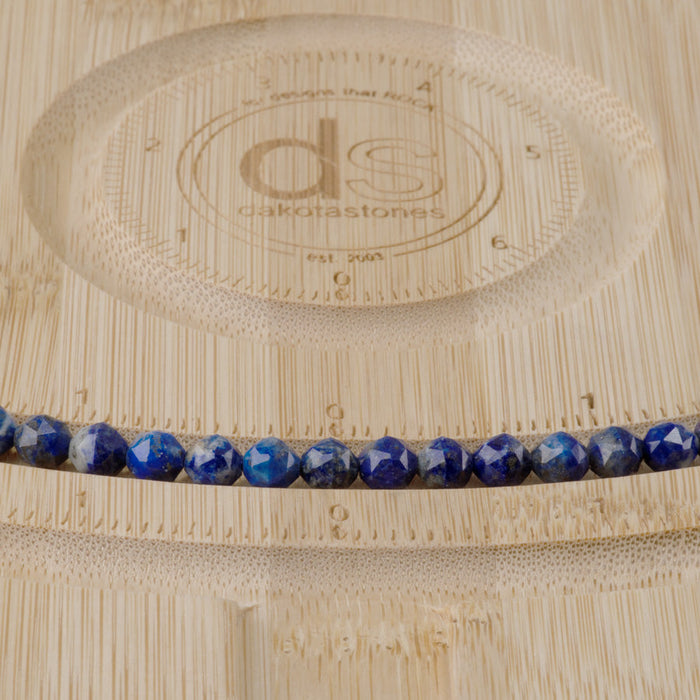 This is a Dakota Stones 6mm Lapis Gemstone strand with double heart faceted round beads in 15-16 inch strand.