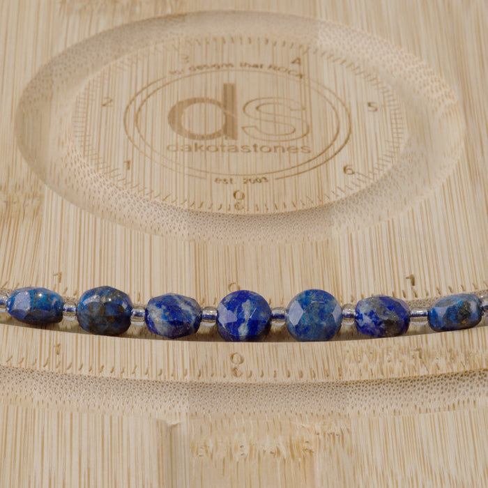 This is a Dakota Stones 8mm Lapis Gemstone strand with star cut faceted coin beads in 15-16 inch strand.