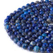 This is a Dakota Stones 8mm Lapis Gemstone strand with double heart faceted round beads in 15-16 inch strand.
