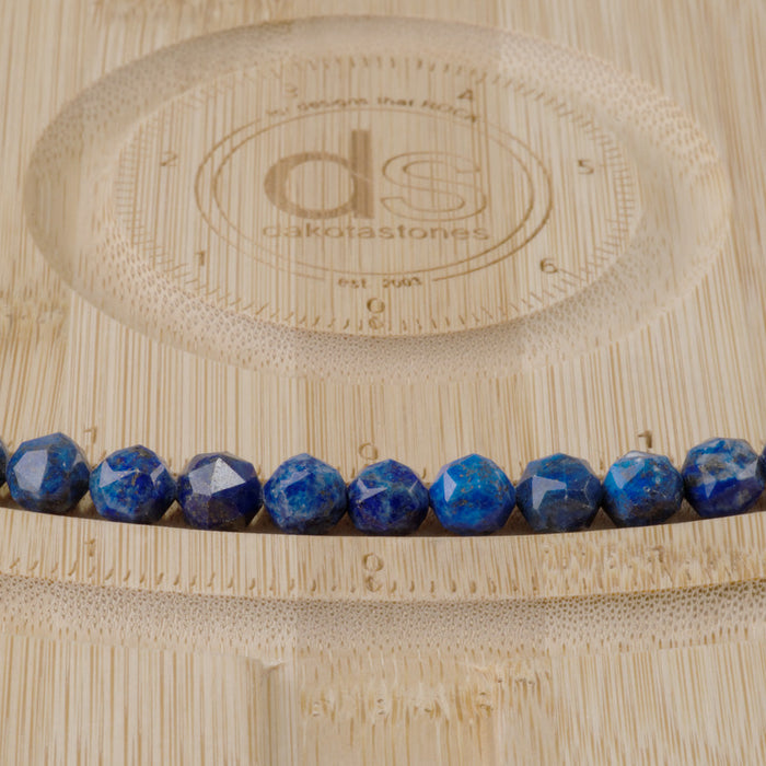 This is a Dakota Stones 8mm Lapis Gemstone strand with double heart faceted round beads in 15-16 inch strand.