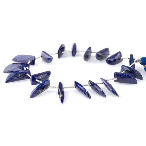 This is a Dakota Stones 8x20mm Lapis Teeth Gemstone strand with faceted beads in 9 inch strand.