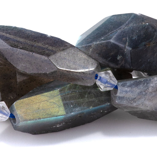 This is a Dakota Stones 12x20-18x25mm Labradorite Gemstone strand with AA grade faceted nugget beads in 15-16 inch strand.