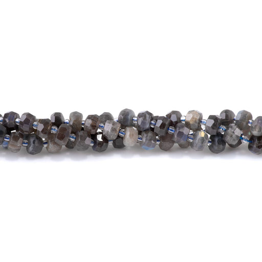 This is a Dakota Stones 5x8mm Dark Labradorite Irr Gemstone strand with faceted rondelle beads in 15-16 inch strand.