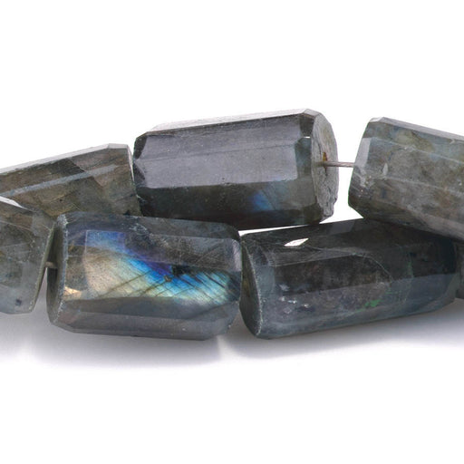 This is a Dakota Stones 9x10-20x25mm Labradorite Tube Gemstone strand with faceted irregular beads in 8 inch strand.