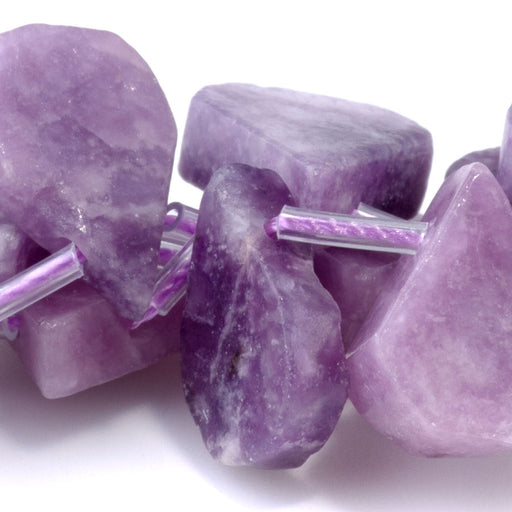 This is a Dakota Stones 9x13-12x16mm Lepidolite Top Drill Flat Gemstone strand with irregular drop beads in 15-16 inch strand.