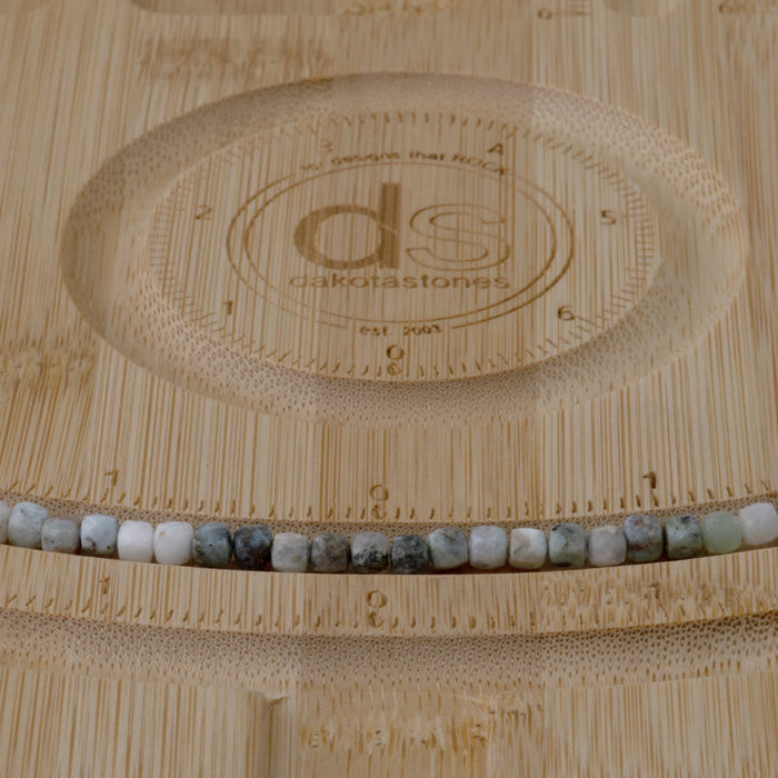 This is a Dakota Stones 4mm Larimar Matrix Gemstone strand with faceted cube beads in 15-16 inch strand.