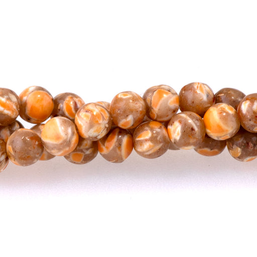 This is a Dakota Stones 4mm Magnesite Orange Gemstone strand with dyed round beads in 15-16 inch strand.