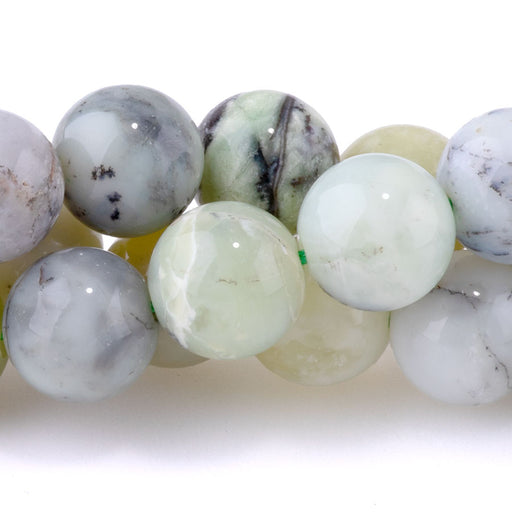 This is a Dakota Stones 10mm Madagascar Green Dendritic Opal Gemstone strand with round beads in 15-16 inch strand.