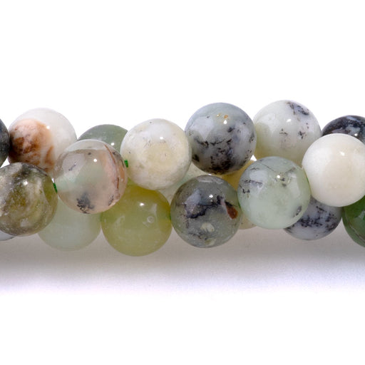 This is a Dakota Stones 6mm Madagascar Green Dendritic Opal Gemstone strand with round beads in 15-16 inch strand.
