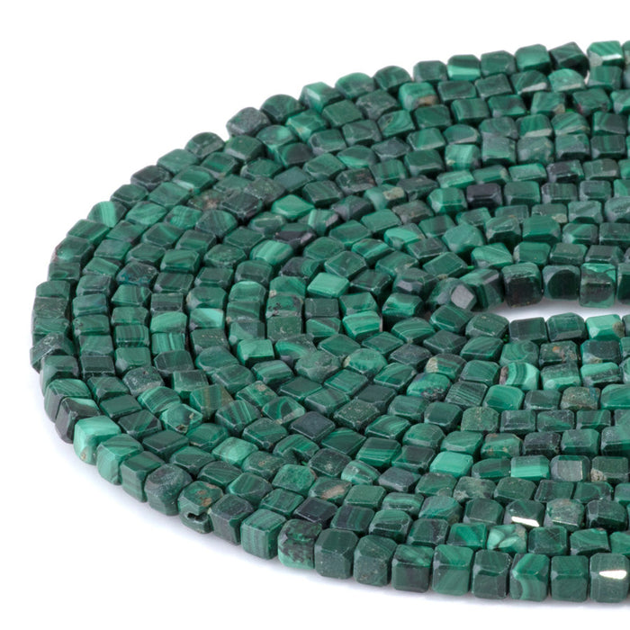 This is a Dakota Stones 4mm Malachite Gemstone strand with A grade table-cut cube beads in 15-16 inch strand.
