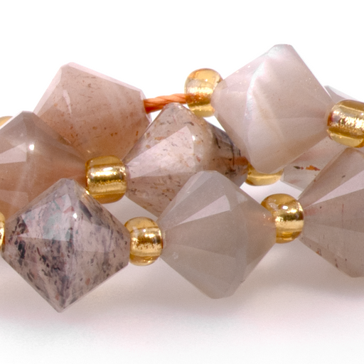 This is a Dakota Stones 8mm Golden Gray Moonstone Bicone Gemstone strand with faceted beads in 15-16 inch strand.