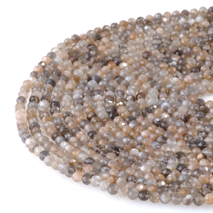 This is a Dakota Stones 4mm Peach Black Moonstone Microfaceted Gemstone strand with round beads in 15-16 inch strand.